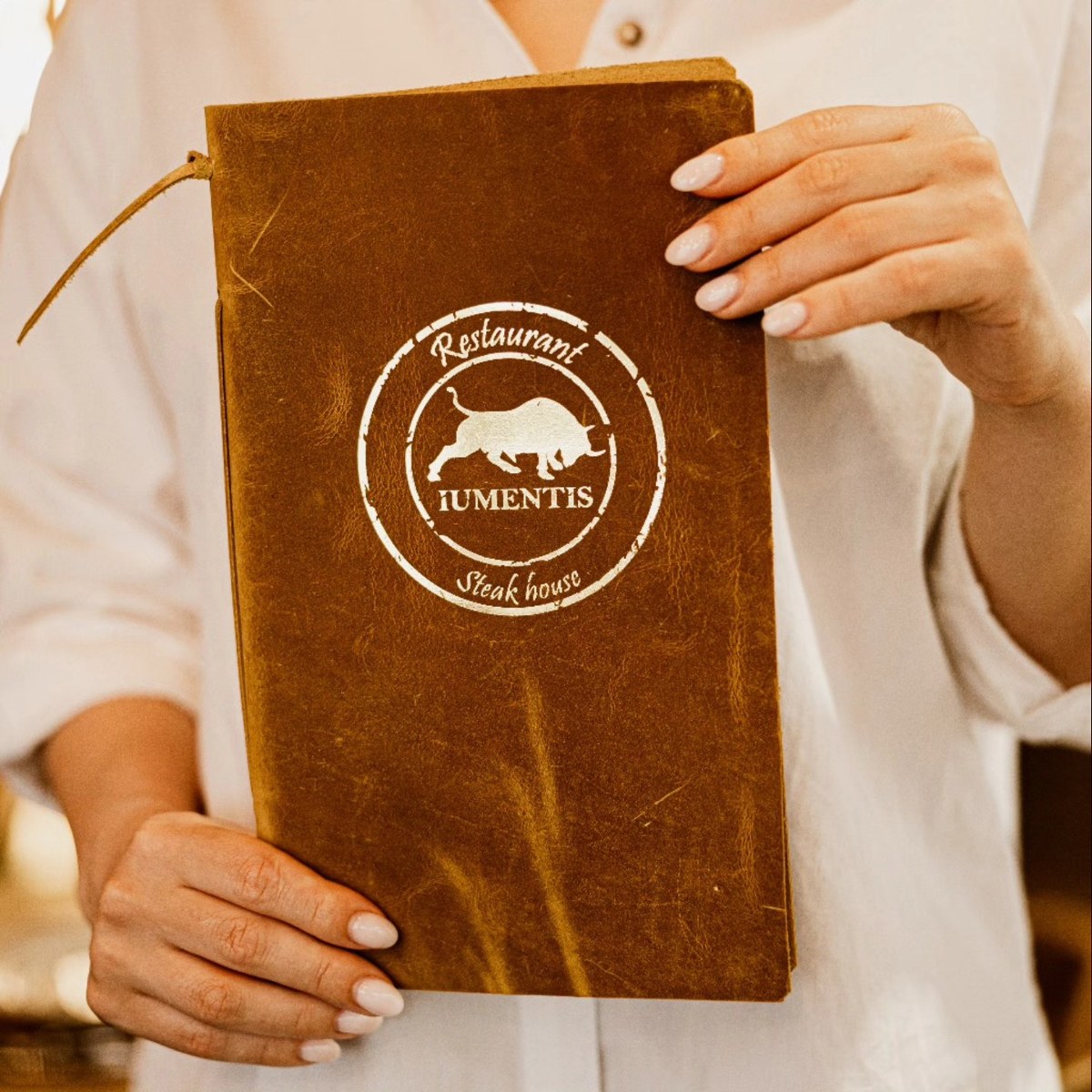 Brown restaurant menu cover with white circular branding