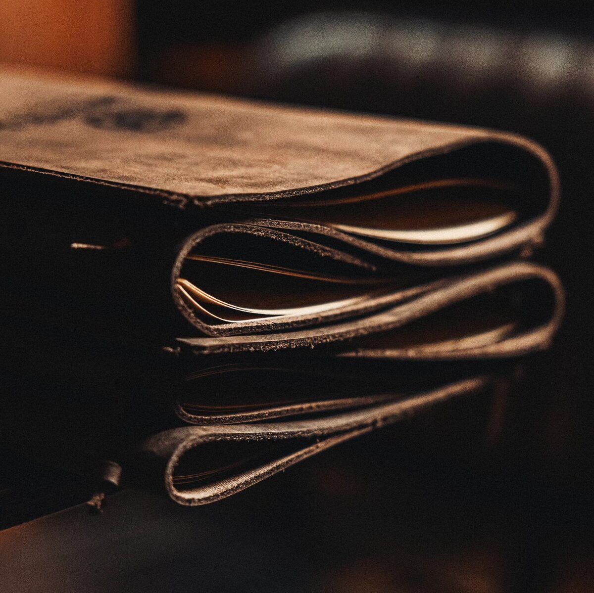 Detail of layered stitched leather menu covers