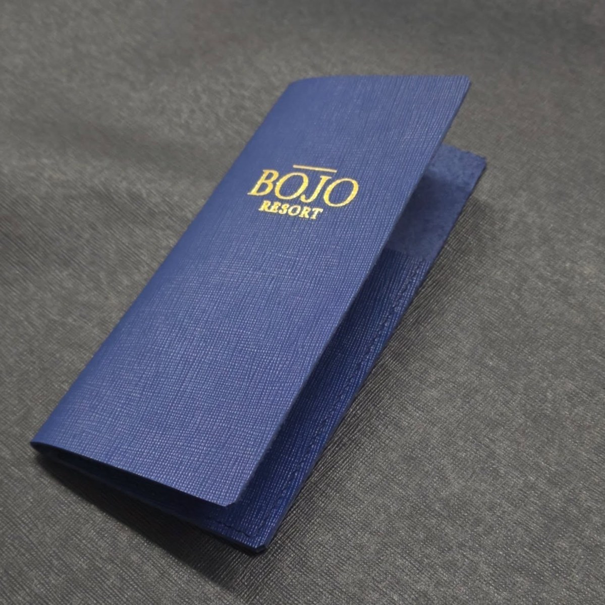 Slim navy beverage menu with gold logo